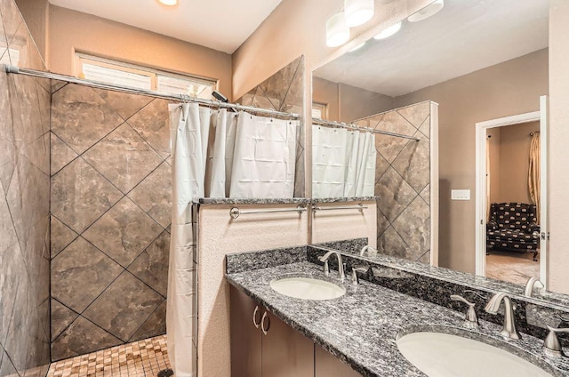 195 Heritage Oaks Dr, Cedar Creek, TX 78612 - bathroom with a tile shower and double vanity