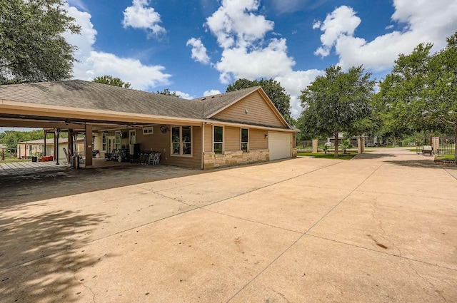195 Heritage Oaks Dr, Cedar Creek, TX 78612 - rear view of house with concrete driveway, a garage, and a shingled roof