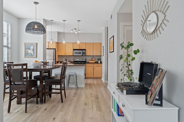 1201 Grove Blvd Unit 2203, Austin, TX 78741 - dining area featuring light wood-style flooring