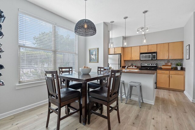 1201 Grove Blvd Unit 2203, Austin, TX 78741 - dining area with light wood-style flooring and plenty of natural light