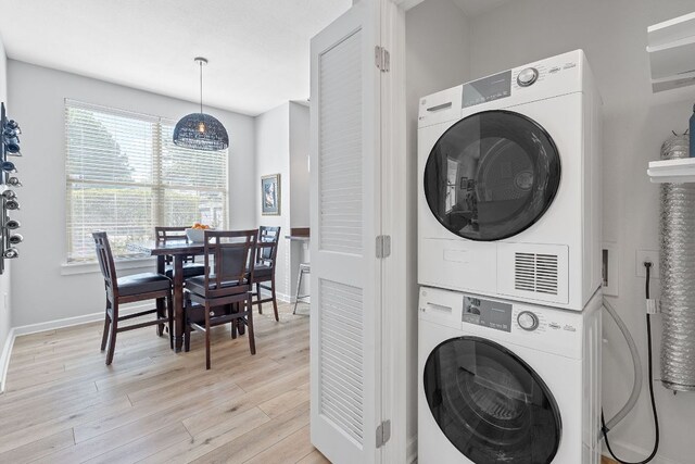 1201 Grove Blvd Unit 2203, Austin, TX 78741 - laundry area with stacked washer / drying machine and light wood finished floors