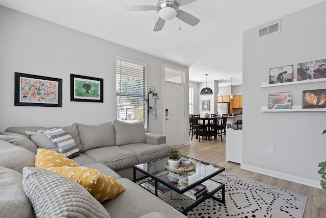 1201 Grove Blvd Unit 2203, Austin, TX 78741 - living room with ceiling fan and light wood-style flooring