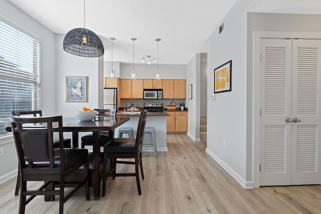 1201 Grove Blvd Unit 2203, Austin, TX 78741 - dining room with light wood-style floors and baseboards