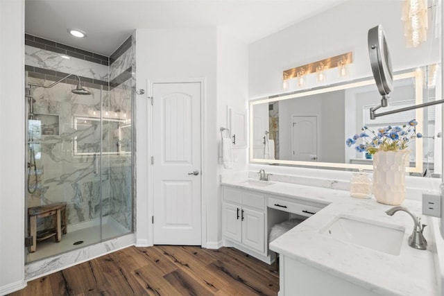 4539 Miraval Loop, Round Rock, TX 78665 - bathroom with a marble finish shower, double vanity, wood finished floors, and recessed lighting