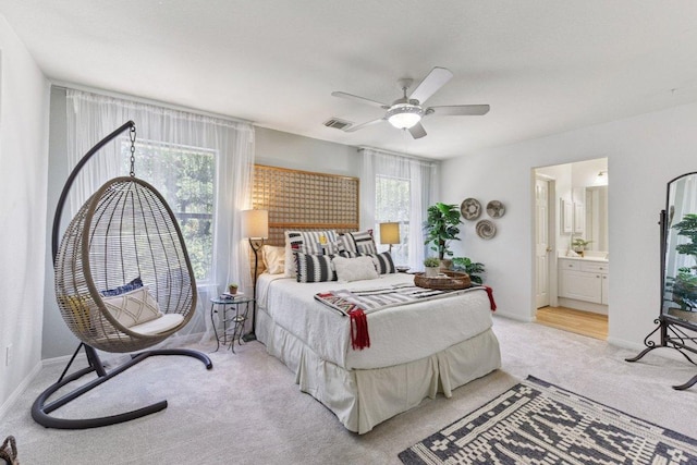 1224 Fall Creek Loop, Cedar Park, TX 78613 - bedroom with light colored carpet, a ceiling fan, and ensuite bath