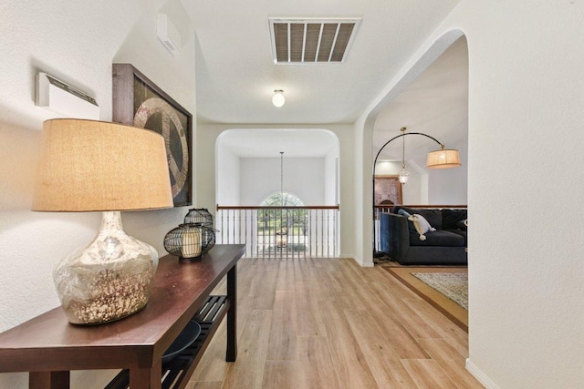 1224 Fall Creek Loop, Cedar Park, TX 78613 - hallway with wood finished floors and arched walkways