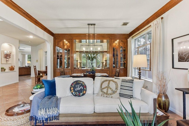 1224 Fall Creek Loop, Cedar Park, TX 78613 - living room featuring a chandelier, tile patterned flooring, and arched walkways