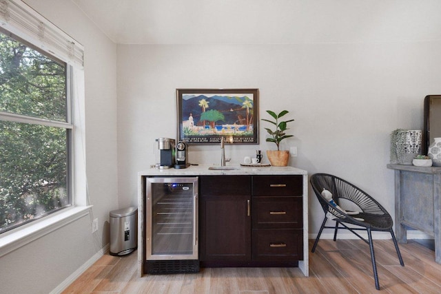 1224 Fall Creek Loop, Cedar Park, TX 78613 - indoor dry bar with wine cooler, light wood-style flooring, and plenty of natural light
