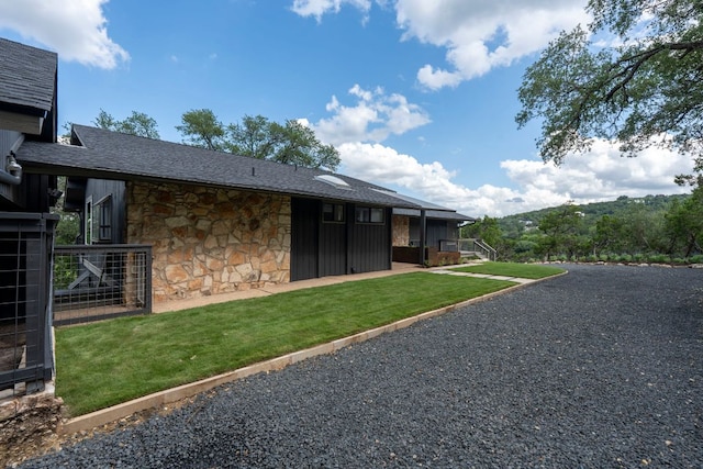 701 Terrace Mountain Dr, West Lake Hills, TX 78746 - rear view of house featuring stone siding, a yard, and a shingled roof