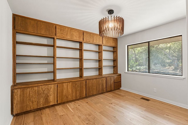 701 Terrace Mountain Dr, West Lake Hills, TX 78746 - spare room with a chandelier and light wood finished floors