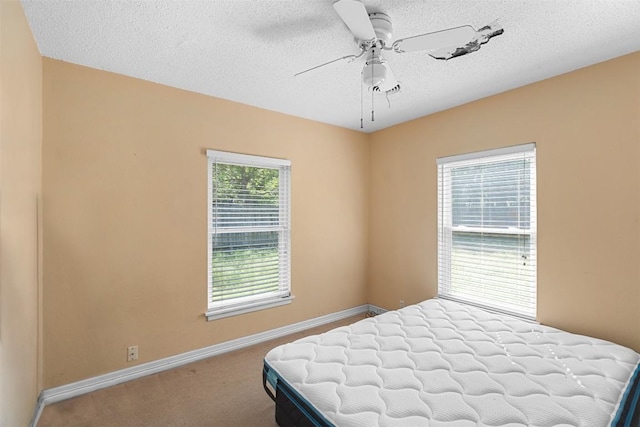 7923 Brockman St, Austin, TX 78757 - carpeted bedroom with a textured ceiling and ceiling fan