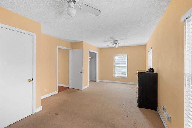 7923 Brockman St, Austin, TX 78757 - unfurnished bedroom featuring carpet floors, a textured ceiling, a closet, and a ceiling fan