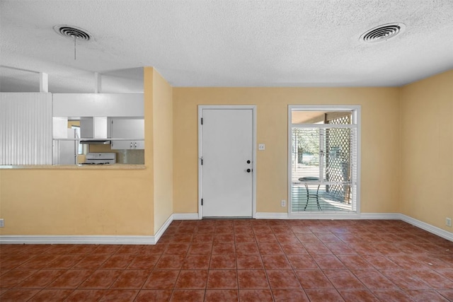 7923 Brockman St, Austin, TX 78757 - tiled entryway featuring a textured ceiling and baseboards