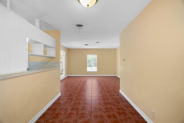 7923 Brockman St, Austin, TX 78757 - spare room with dark tile patterned flooring and a textured ceiling