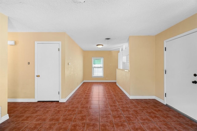 7923 Brockman St, Austin, TX 78757 - tiled entryway featuring a textured ceiling and baseboards
