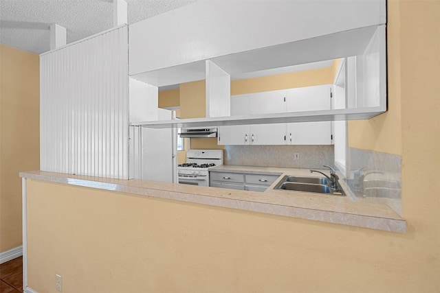 7923 Brockman St, Austin, TX 78757 - kitchen with white range with gas stovetop, ventilation hood, light countertops, white cabinets, and a textured ceiling
