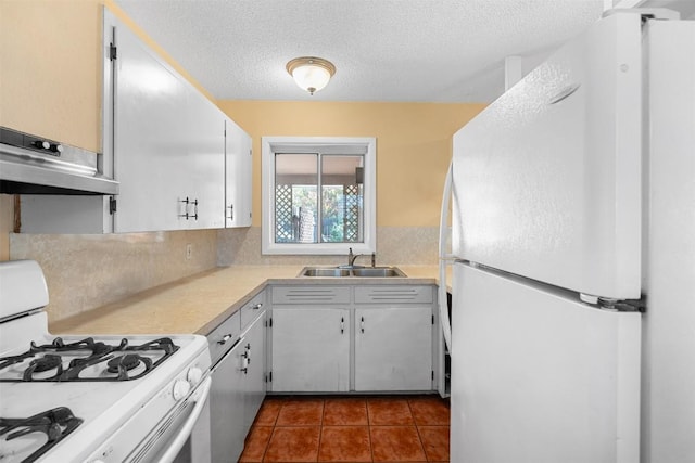 7923 Brockman St, Austin, TX 78757 - kitchen featuring white appliances, under cabinet range hood, light countertops, a textured ceiling, and white cabinets
