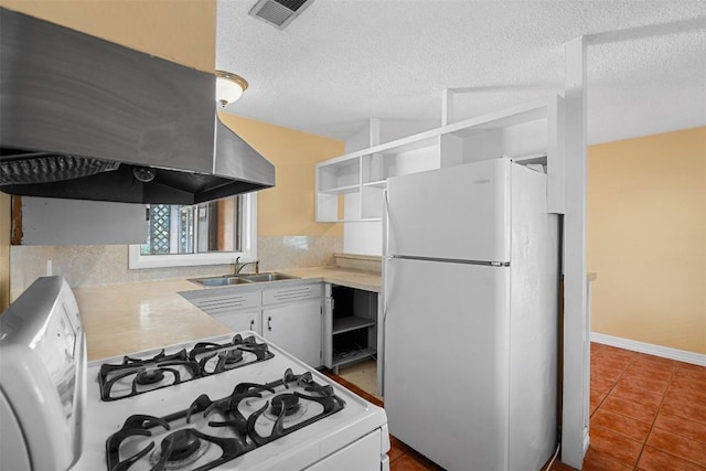 7923 Brockman St, Austin, TX 78757 - kitchen featuring white appliances, open shelves, extractor fan, dark tile patterned floors, and a textured ceiling