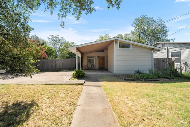 7923 Brockman St, Austin, TX 78757 - mid-century inspired home with an attached carport, concrete driveway, and a patio area
