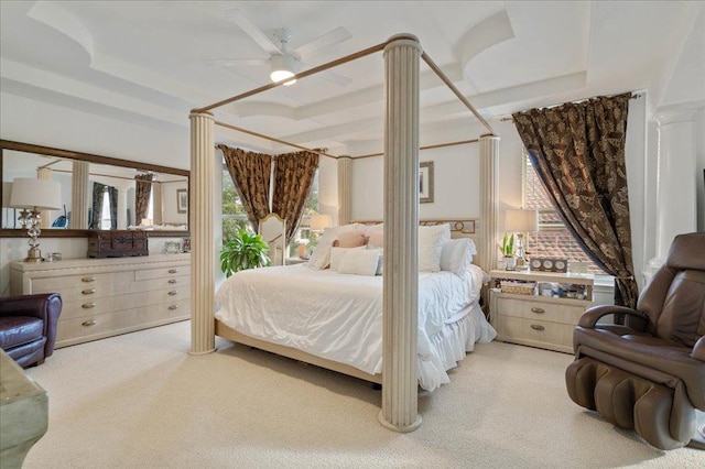 bedroom with carpet flooring, ornate columns, a raised ceiling, and a ceiling fan