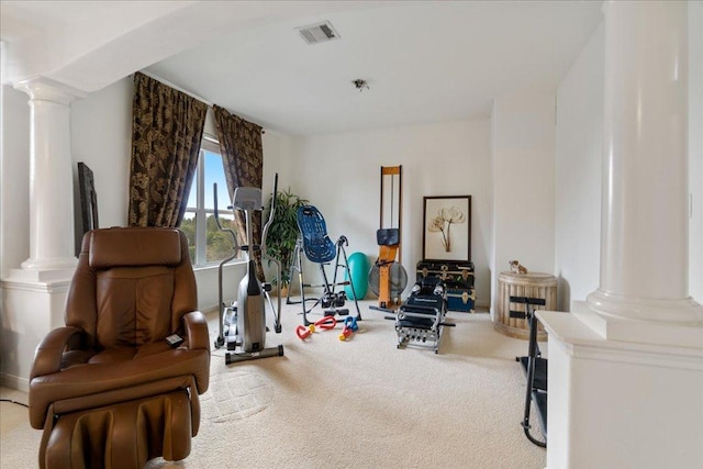 workout room with decorative columns and carpet floors