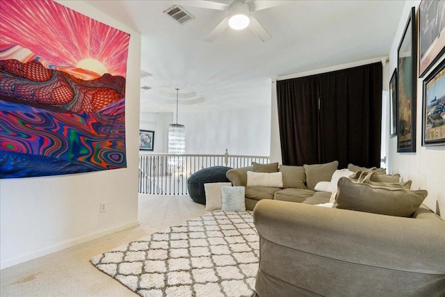 living area with ceiling fan and carpet