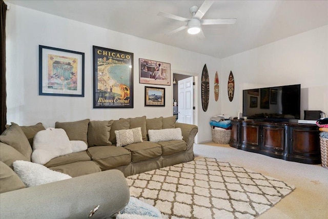 carpeted living area featuring a ceiling fan