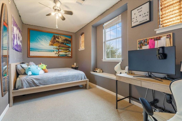 carpeted bedroom featuring baseboards and a ceiling fan