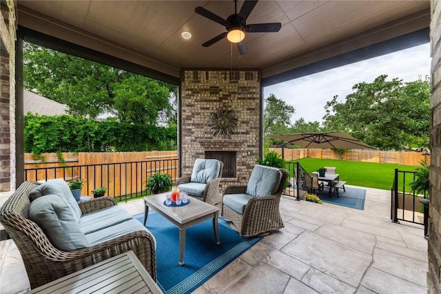 4644 Arques Ave, Round Rock, TX 78681 - fenced backyard with a patio, an outdoor living space with a fireplace, outdoor dining space, and a ceiling fan