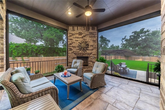 4644 Arques Ave, Round Rock, TX 78681 - fenced backyard with a patio area, an outdoor living space with a fireplace, and a ceiling fan