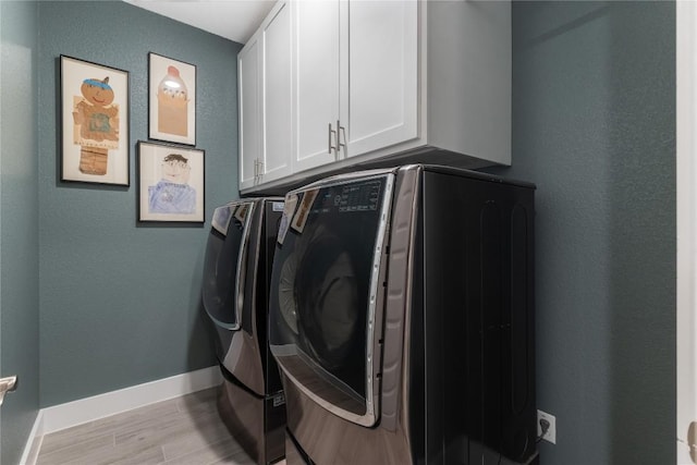 4644 Arques Ave, Round Rock, TX 78681 - laundry area with cabinet space, washing machine and dryer, wood finished floors, and a textured wall