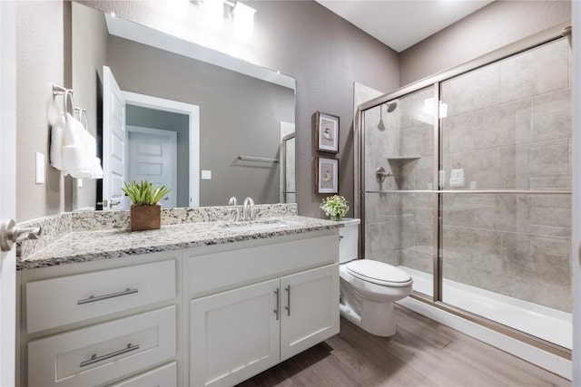 4644 Arques Ave, Round Rock, TX 78681 - bathroom featuring wood finished floors, vanity, and a shower stall