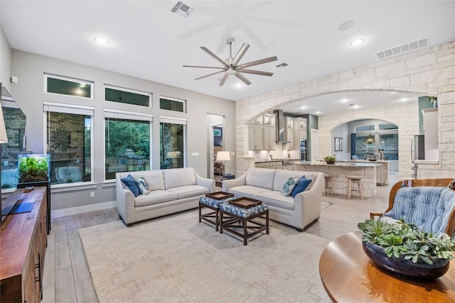 4644 Arques Ave, Round Rock, TX 78681 - living area featuring arched walkways, a ceiling fan, light wood-type flooring, and recessed lighting