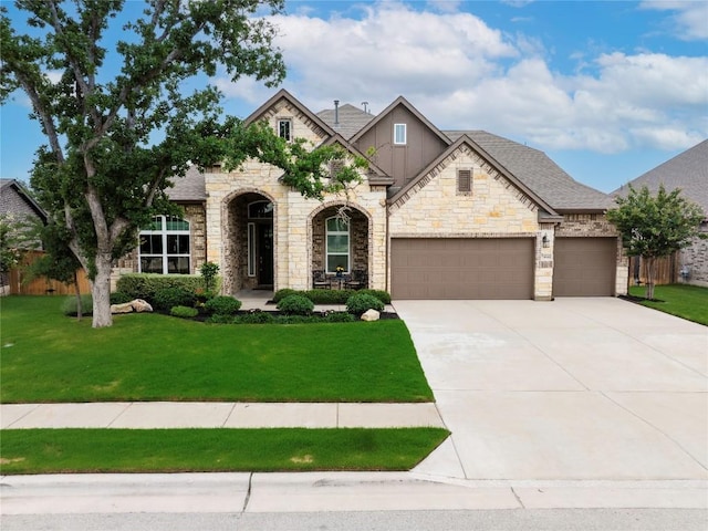 4644 Arques Ave, Round Rock, TX 78681 - french country style house featuring a front lawn, driveway, stone siding, and a garage