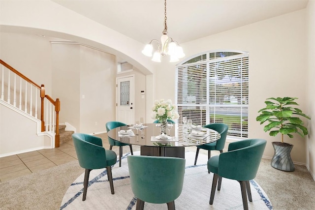 36 White Magnolia Cir, Austin, TX 78734 - tiled dining space featuring a chandelier, arched walkways, stairway, and carpet floors