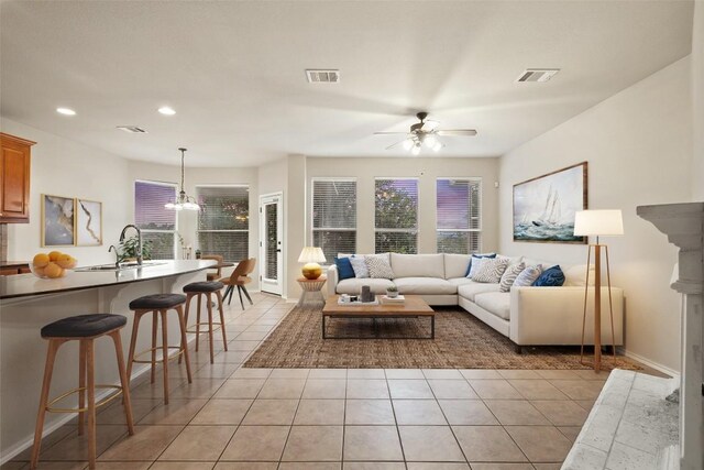 36 White Magnolia Cir, Austin, TX 78734 - living room featuring light tile patterned floors, ceiling fan, recessed lighting, and a chandelier