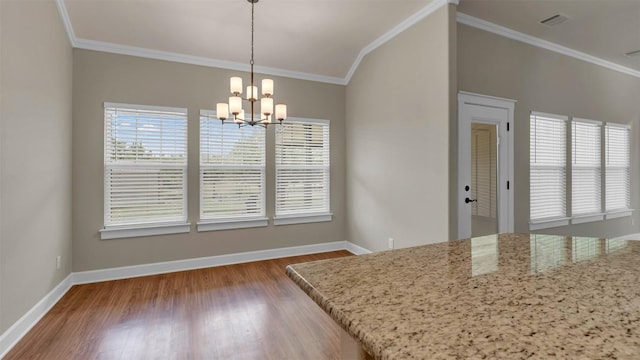 208 Rachel Loop, Burnet, TX 78611 - unfurnished dining area with crown molding, a chandelier, wood finished floors, and lofted ceiling