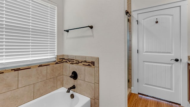 208 Rachel Loop, Burnet, TX 78611 - bathroom with a garden tub and wood finished floors