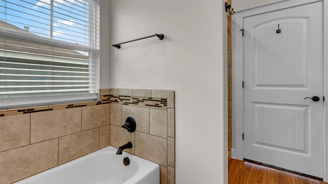 208 Rachel Loop, Burnet, TX 78611 - full bath featuring a bath and wood finished floors