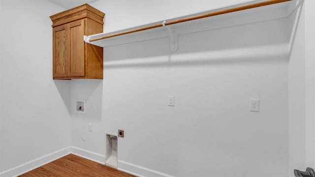 208 Rachel Loop, Burnet, TX 78611 - washroom featuring electric dryer hookup, washer hookup, wood finished floors, and cabinet space