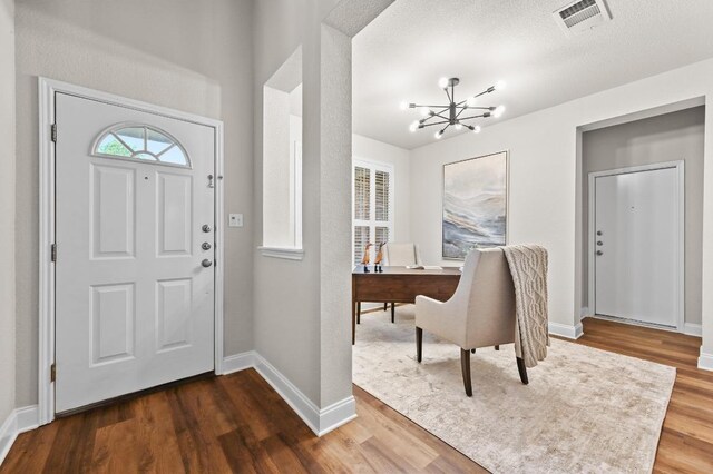 10421 Beard Ave, Austin, TX 78748 - entrance foyer with a chandelier and dark wood-style flooring