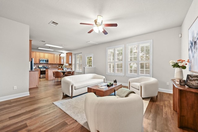 10421 Beard Ave, Austin, TX 78748 - living area with ceiling fan and wood finished floors