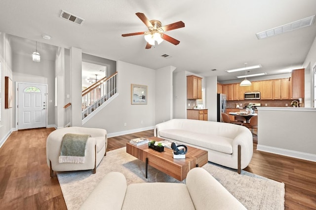 10421 Beard Ave, Austin, TX 78748 - living area featuring ceiling fan, light wood-style flooring, and stairs