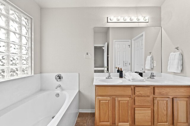 10421 Beard Ave, Austin, TX 78748 - full bath with a garden tub, double vanity, and plenty of natural light