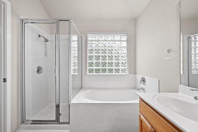10421 Beard Ave, Austin, TX 78748 - bathroom with a shower stall, vanity, a bath, and a textured wall