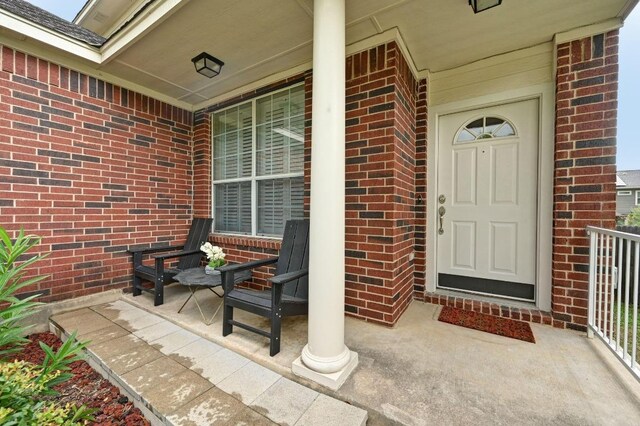 10421 Beard Ave, Austin, TX 78748 - doorway to property featuring a porch and brick siding