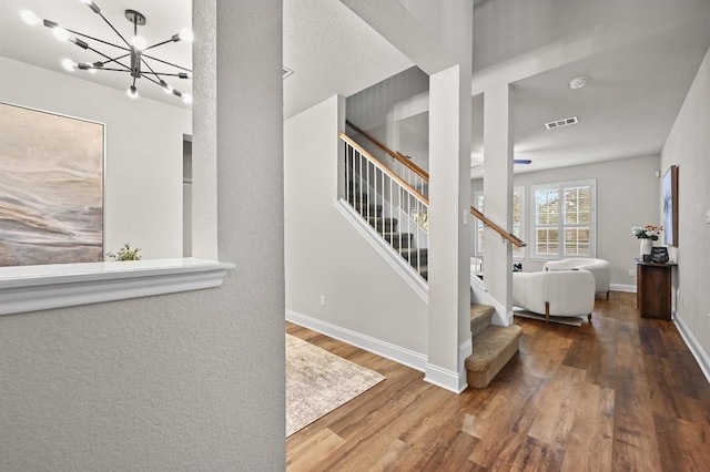 10421 Beard Ave, Austin, TX 78748 - foyer entrance featuring a chandelier, wood finished floors, and stairway