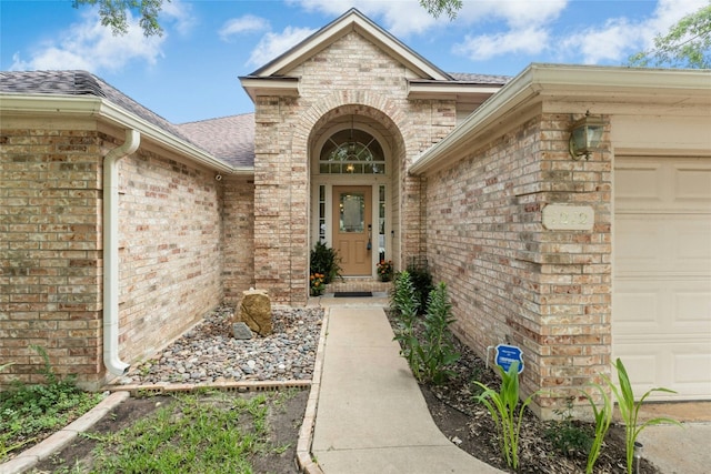 1212 Dove Cir, Cedar Park, TX 78613 - entrance to property featuring an attached garage, brick siding, and roof with shingles