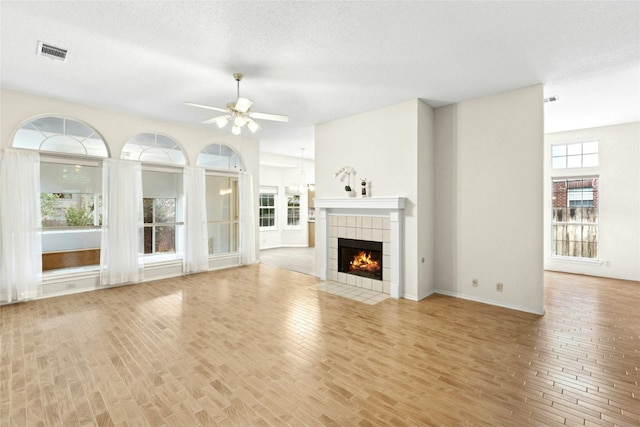1212 Dove Cir, Cedar Park, TX 78613 - unfurnished living room with ceiling fan, a fireplace, and wood finished floors