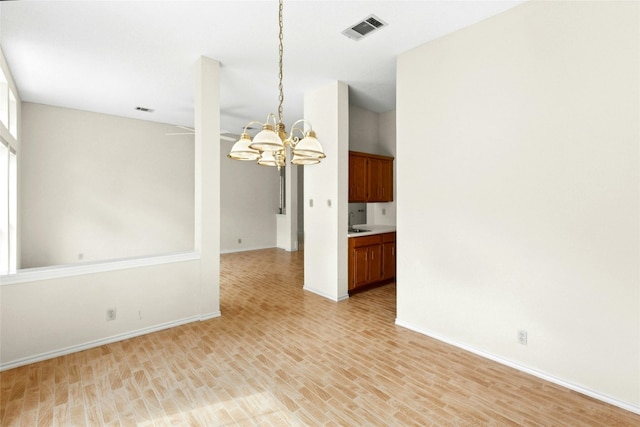 1212 Dove Cir, Cedar Park, TX 78613 - spare room featuring a chandelier and light wood-style floors
